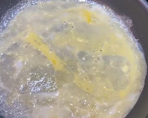 Pour the beaten egg over the set batter and tilt the pan so it spreads into a thin, even layer. Keep the heat at medium-low and let the egg just barely set.