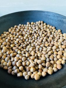 Stir the hazelnuts continuously in the dry pan over low heat