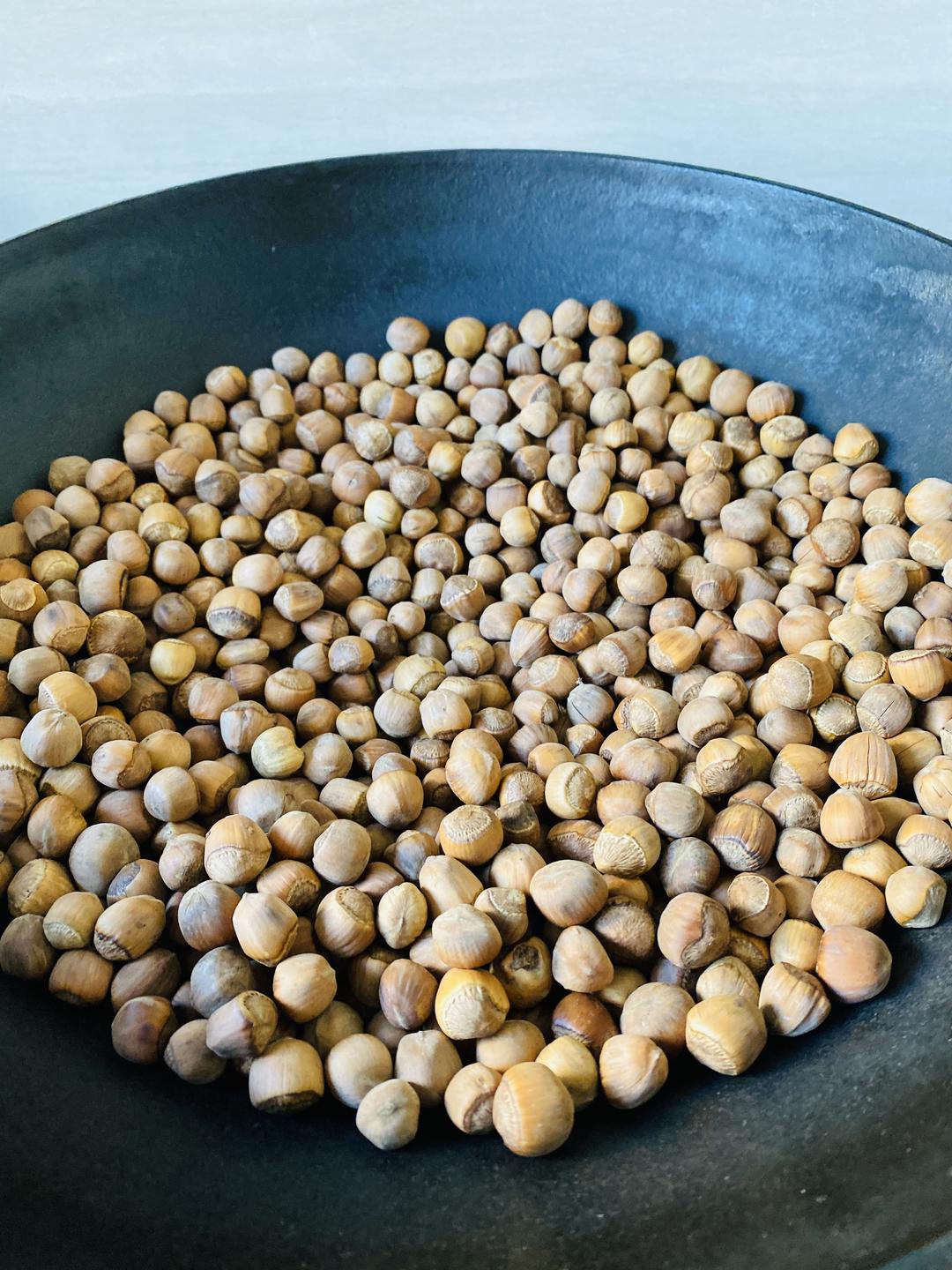 Stir the hazelnuts continuously in the dry pan over low heat
