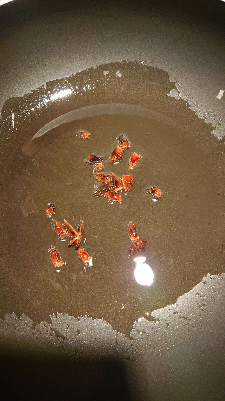 Fry the star anise in oil over medium heat until it darkens, then remove it