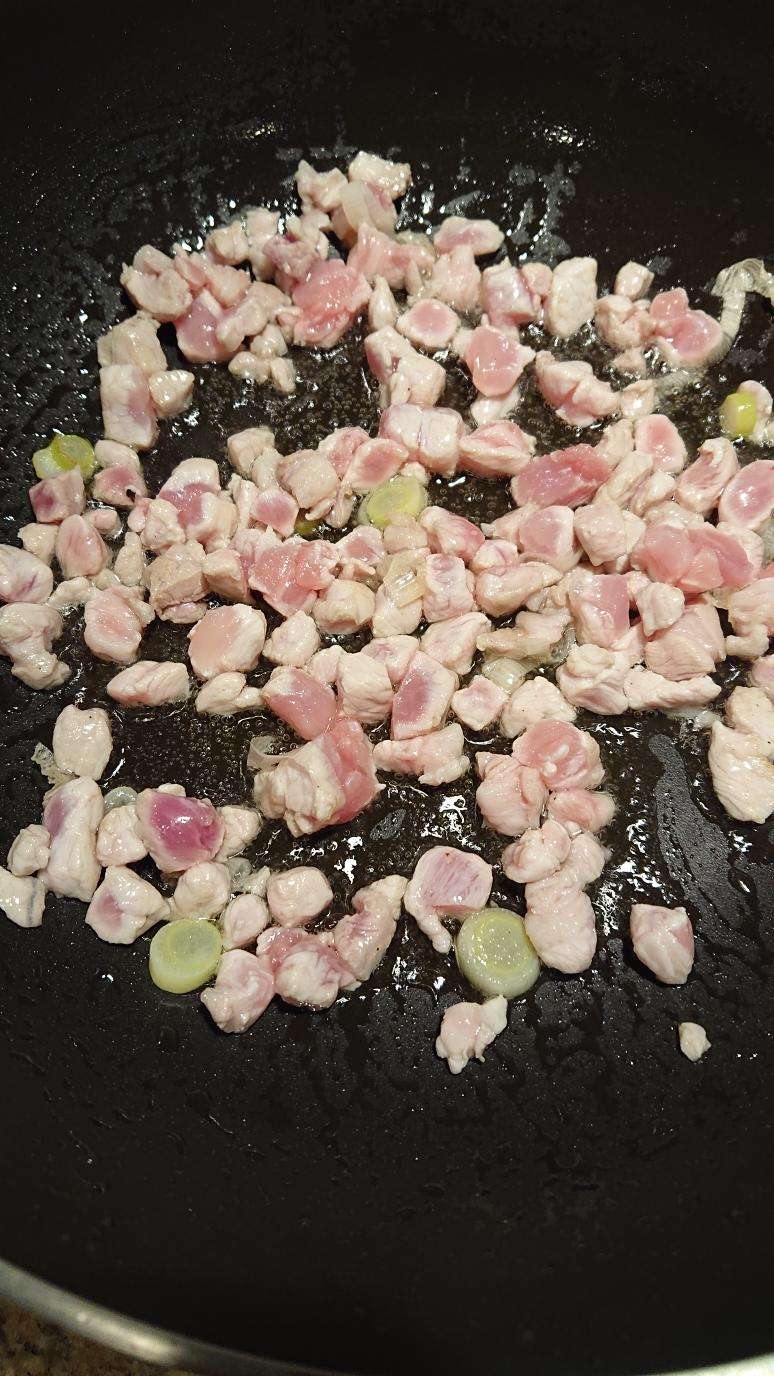 Stir-fry the pork with scallion whites until it turns white, then add wine