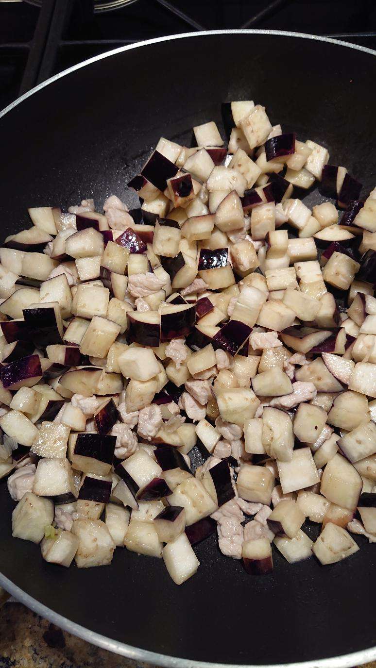 Add the diced eggplant and stir-fry until it softens and absorbs the oil