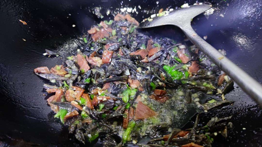Add the diced Xuanwei ham and stir-fry until its savory aroma blooms.