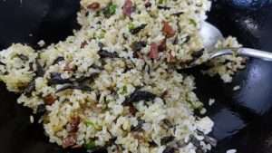 Drizzle the light soy sauce along the hot wok edge and toss the rice to combine.