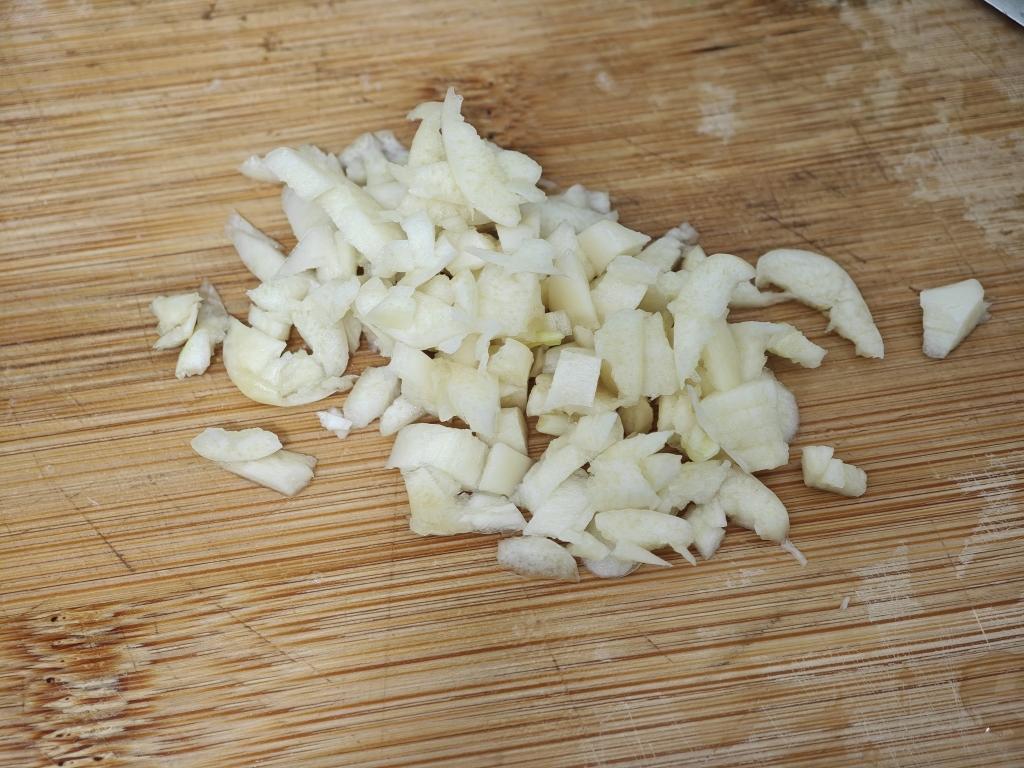 Smash 2 garlic cloves and mince