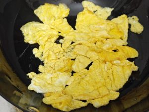 Break the set egg into pieces and set aside