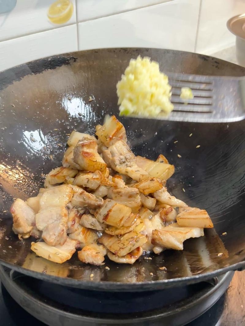 Add half of the minced garlic and fry until golden.