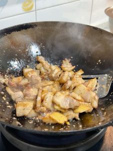 Add about 70 ml of light soy sauce along the hot wok edge to release its aroma