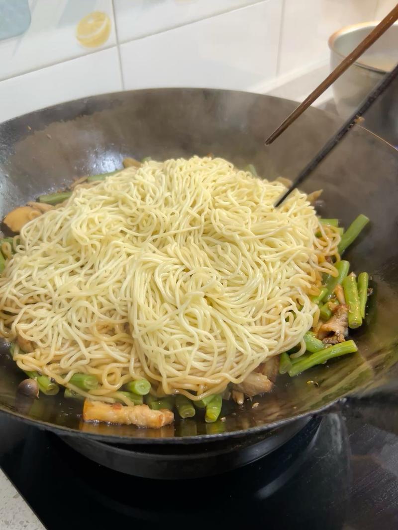 The noodles will have steamed into one mass; flip them over with chopsticks, then turn off the heat.