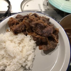 Japanese-style beef rice bowl with simmered hot-pot beef, onion and glossy soy-mirin sauce over rice