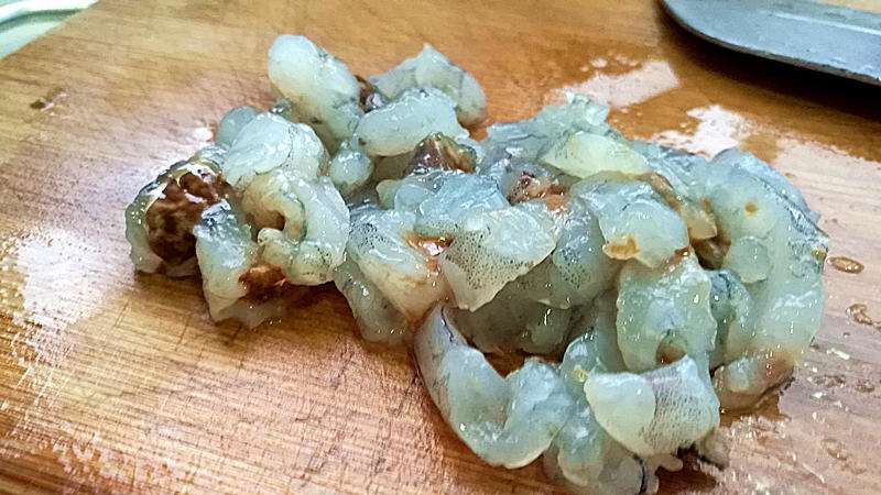 Peel and devein the shrimp, then cut them into small pieces.