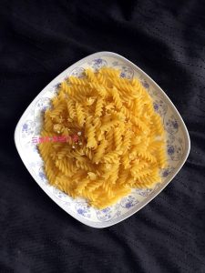 Measure a serving of spiral pasta