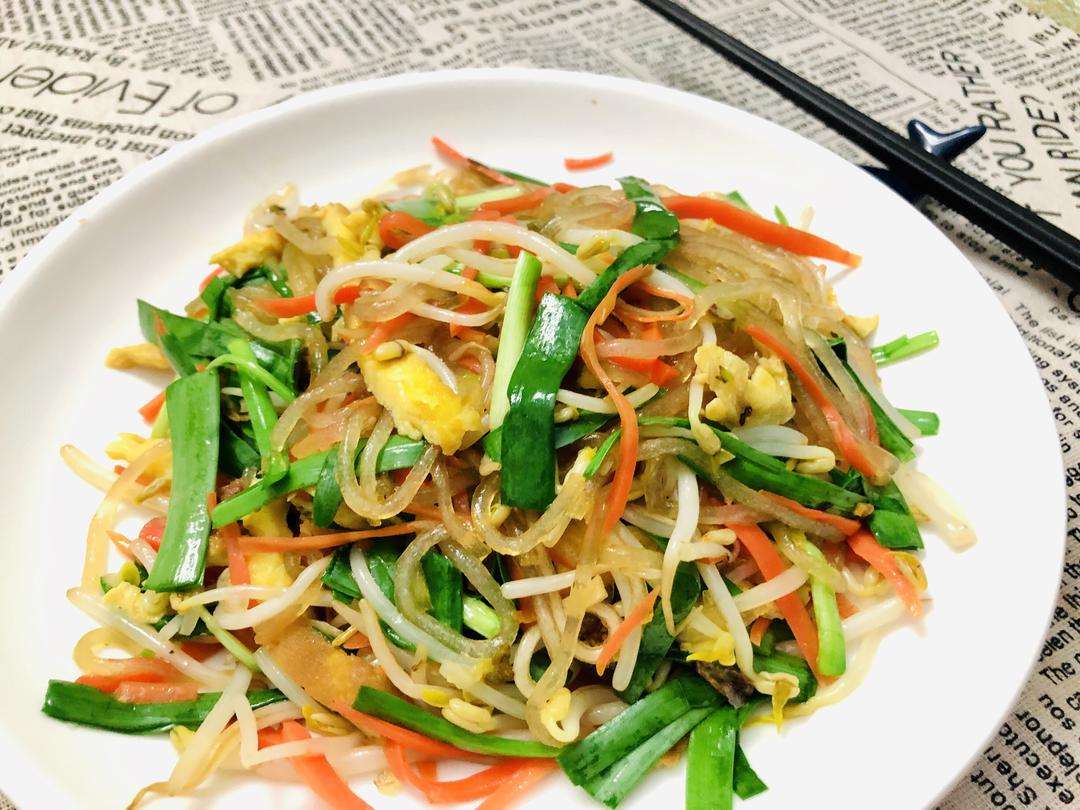 Colorful stir-fried mixed vegetables with bean sprouts, carrot, egg, and chives