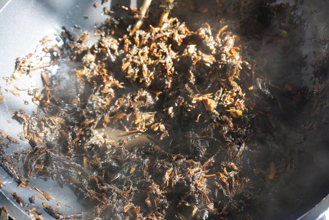 Pour the sauce over the meicai and stir-fry until well coated.