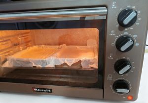 Set the pans in the oven and bake at 130 degrees C for 60 minutes, resisting the urge to open the door.