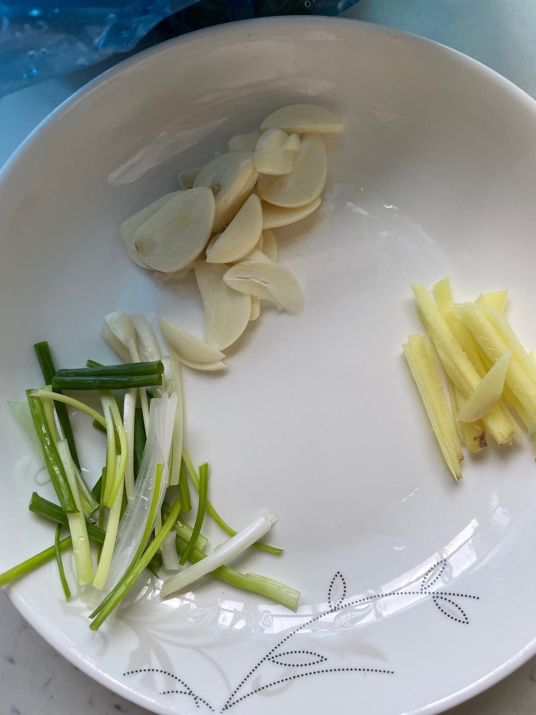 Prep the aromatics: ginger shreds, garlic sli