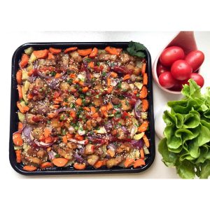 Oven-roasted pork belly slices over roasted potatoes and carrots