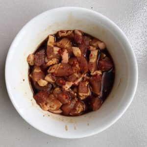 Marinate the thick pork belly slices in wine, soy, oyster sauce, cumin, and pepper