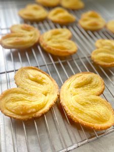 Transfer the baked palmiers to a wire rack. They firm up as they cool — the caramelized sugar sets into a glassy shell within a few minutes. Let them cool completely before stacking, or the steam will soften them.
