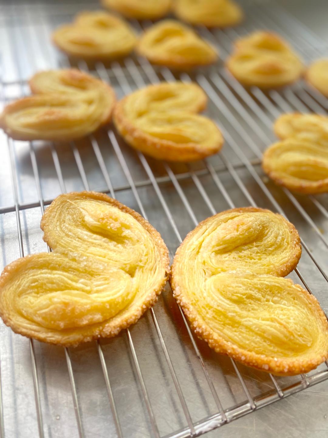 Transfer the baked palmiers to a wire rack. They firm up as they cool — the caramelized sugar sets into a glassy shell within a few minutes. Let them cool completely before stacking, or the steam will soften them.