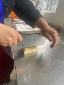 Using a sharp knife, cut the frozen block into 1 cm (about 1/2 in) strips. Arrange them cut-side up on a parchment-lined baking tray, leaving a few centimeters between them — they spread and puff as they bake.