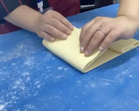 Mark the long edge into 6 equal portions. Fold the dough back and forth over those marks like a paper fan or accordion, so the sugar is trapped between the layers. Freeze the folded block for 30 minutes until firm.