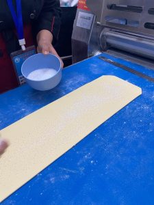 Roll the laminated dough out to about 20 x 57 cm (8 x 22.5 in). Sprinkle the granulated sugar evenly over the whole surface, then trim the edges to a clean 18 x 56 cm (7 x 22 in) rectangle.