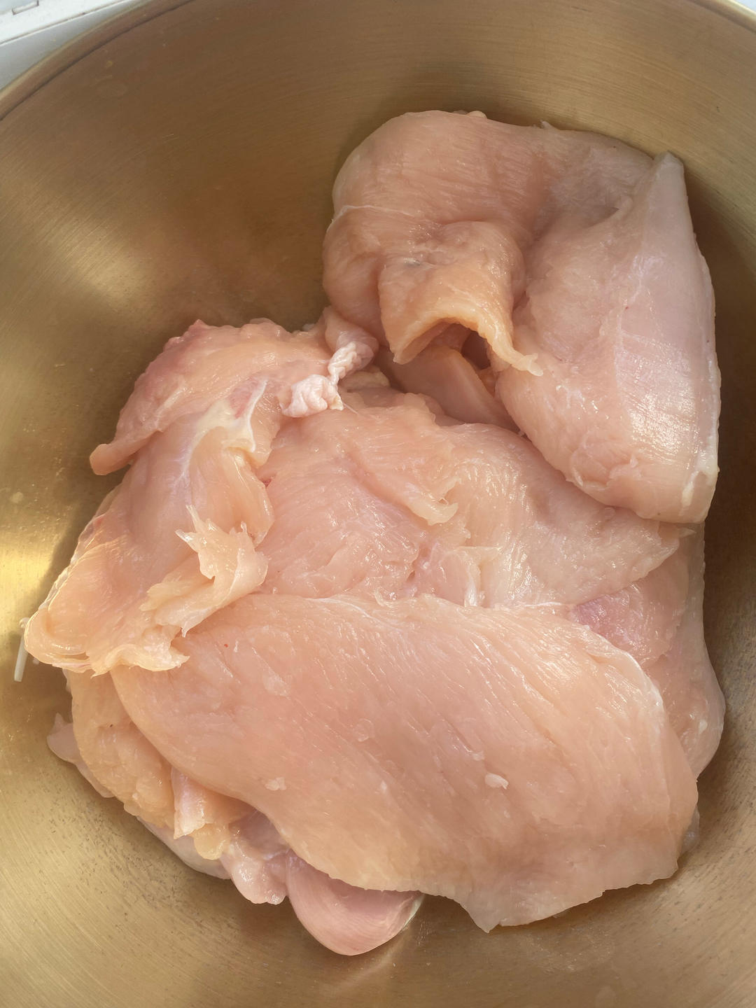 Rinse each chicken breast and slice evenly in
