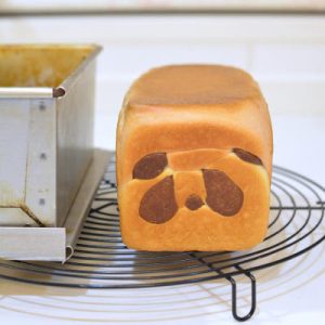 Bake at 200 degrees C for 30 minutes, then unmold and cool completely before slicing to reveal the panda face.