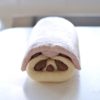 The assembled loaf should look like a tidy, sealed block with the face hidden inside.