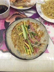 Arrange sweet bean sauce, potato shreds, bean sprouts, ham, egg, scallion, and cucumber