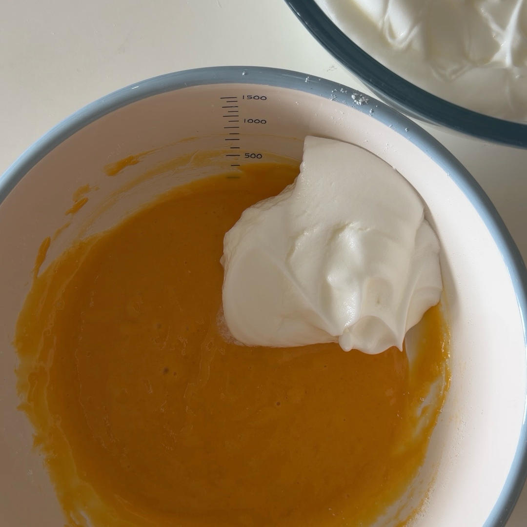 Fold one spoonful of meringue into the yolk b
