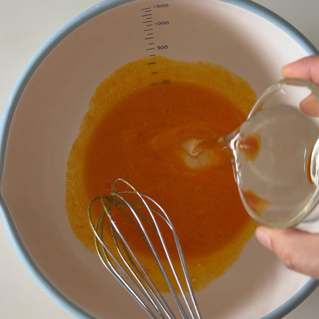 Whisk the yolks, then add the corn oil