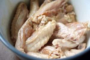 Halve the chicken wingettes and coat them with the ginger, scallion, soy, and wine marinade