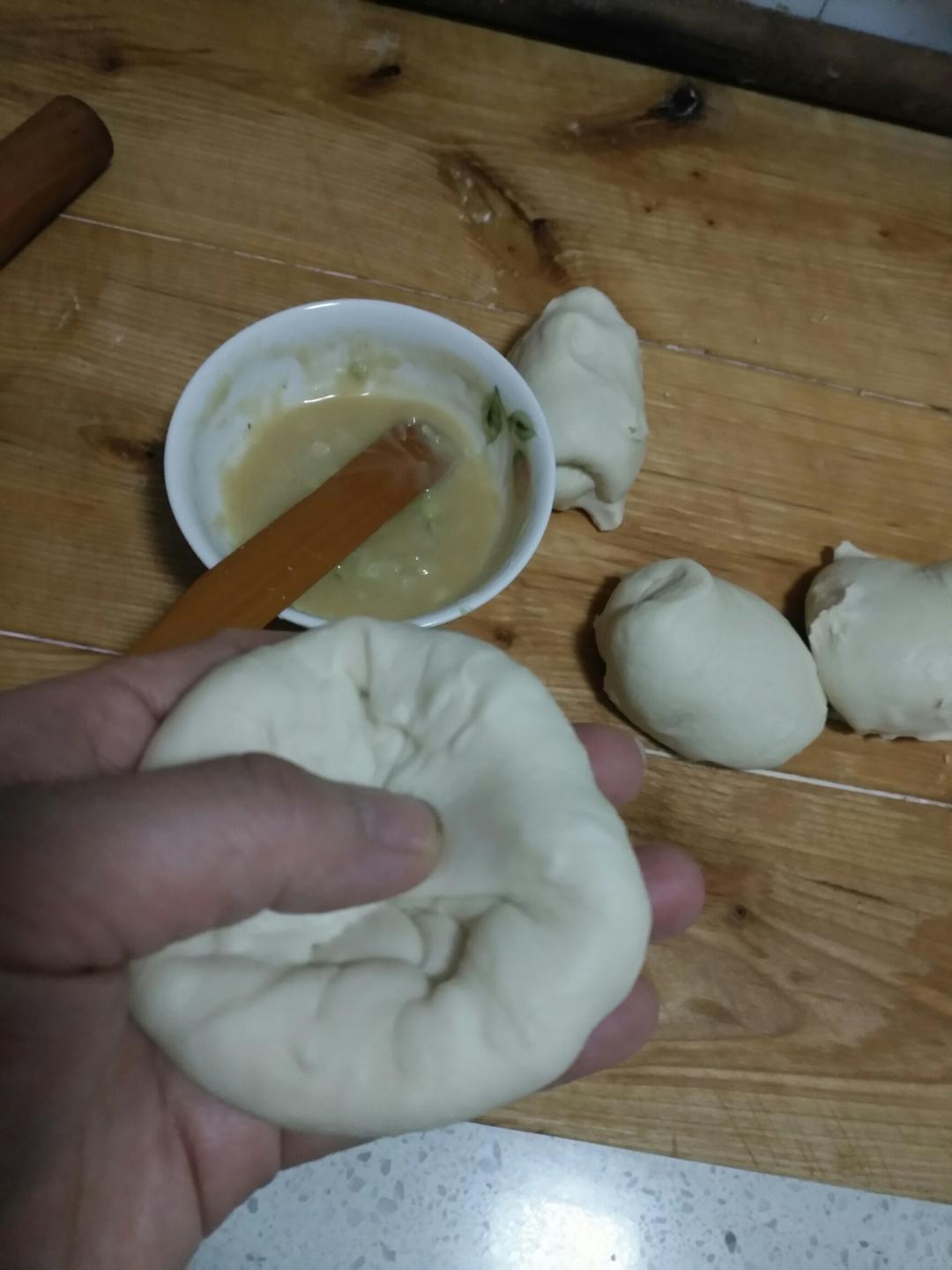 Add the oil paste to the center well of the dough