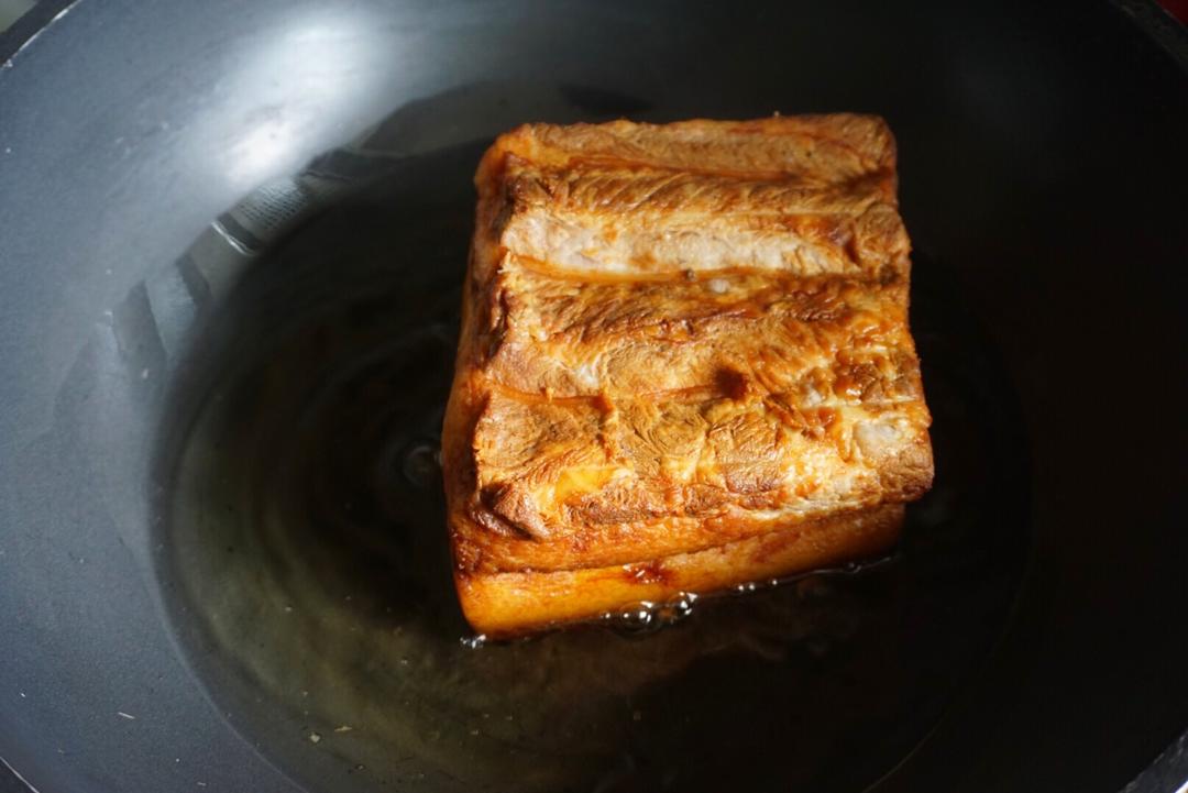 The pork skin is blistered and deep amber after frying; let it cool.