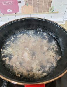 When all the pork is in, bring the pot back to a full boil, then use a spatula to gently release any pieces that have settled and stuck to the bottom.