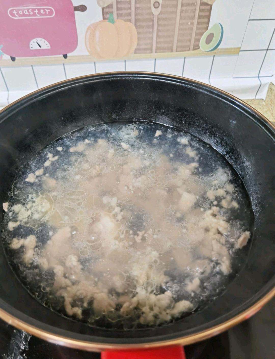 When all the pork is in, bring the pot back to a full boil, then use a spatula to gently release any pieces that have settled and stuck to the bottom.