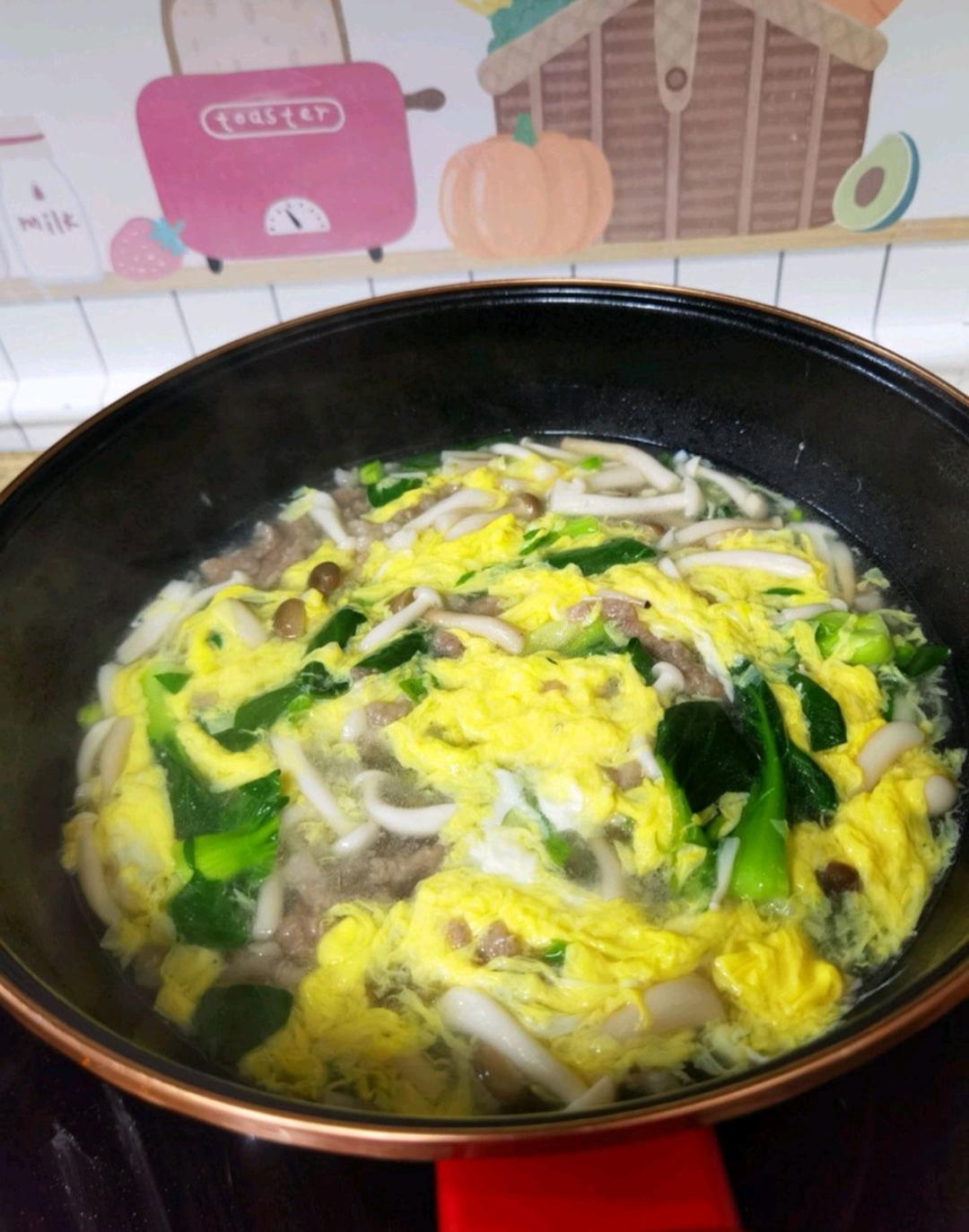 Sprinkle with the sliced scallions and serve immediately, ladling pork, greens and broth into warmed bowls.