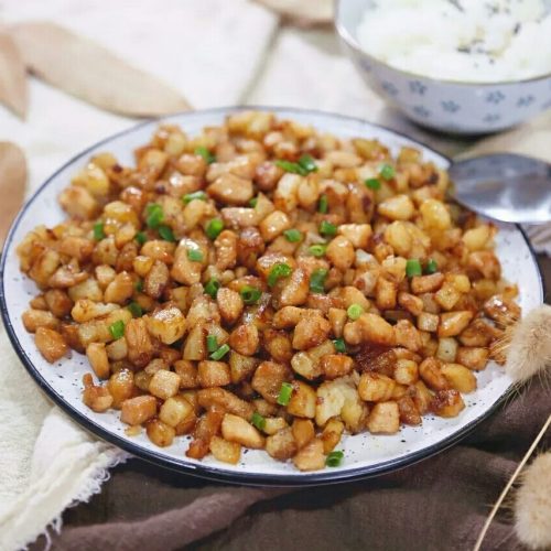 Golden potato cubes with diced chicken breast in a simple soy glaze