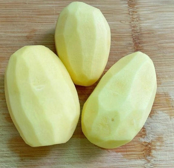 Peel the potatoes with a vegetable peeler and drop them into a bowl of cold water as you go so they don't discolor.