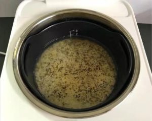 Add water to one finger-joint above the grains, close the rice cooker lid and press cook.