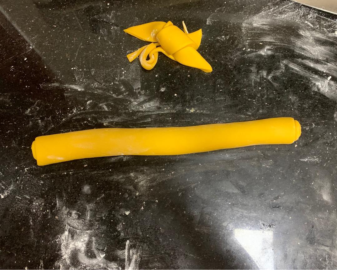 Brushing the dough surface with water and rolling up