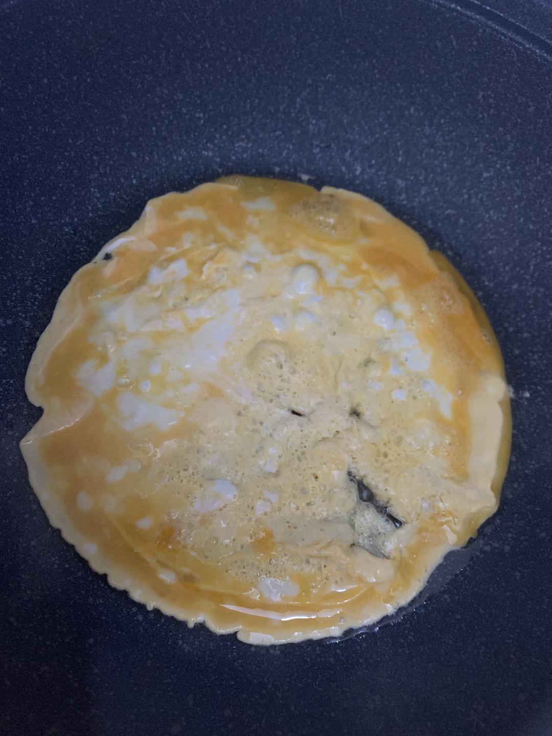 Scrambled eggs cooked into thin shreds