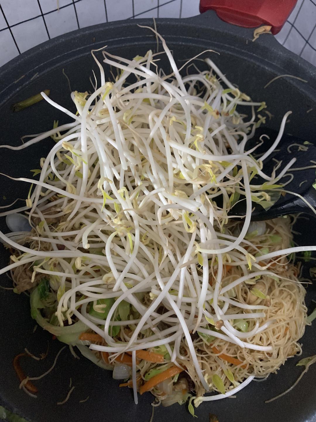 Adding mung bean sprouts and stir-frying