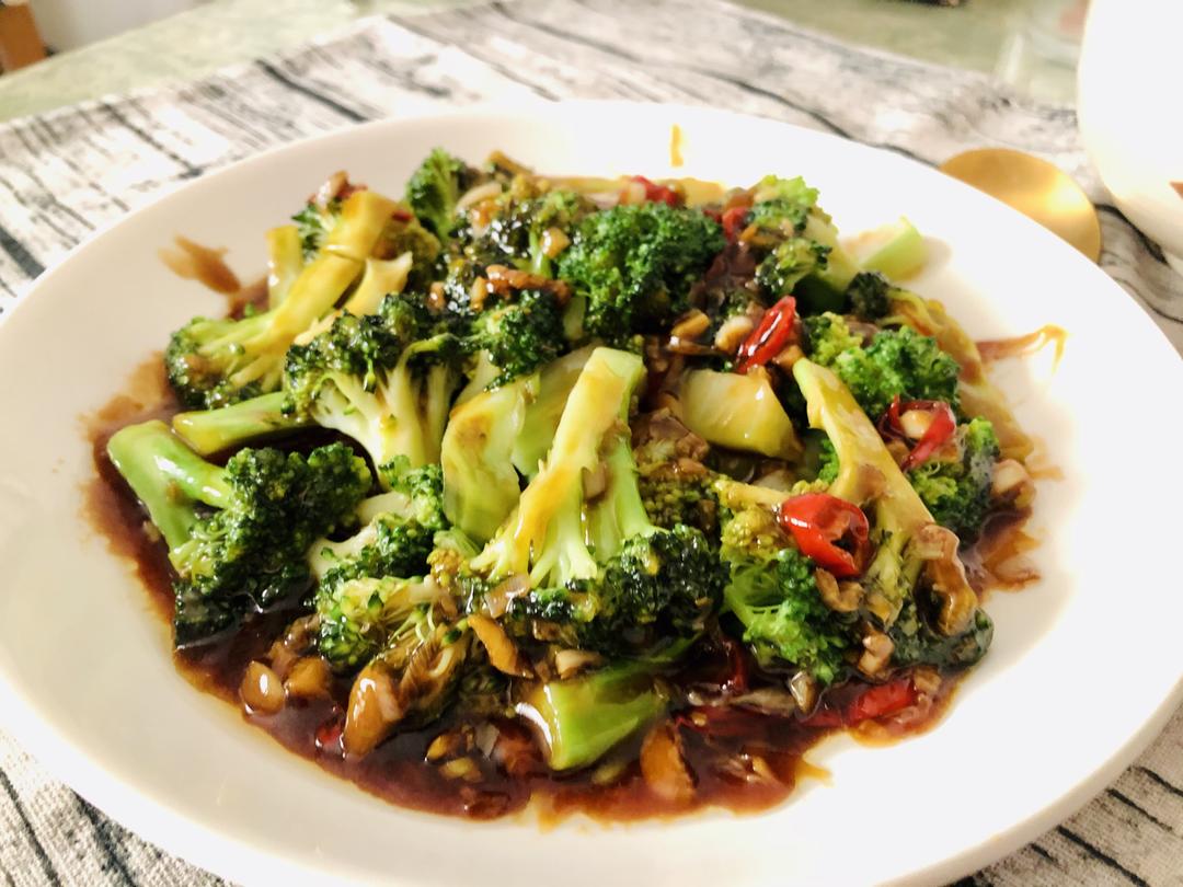 Tossing the broccoli to coat with sauce