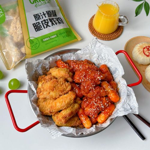 Double-flavor fried chicken with rice cakes, half in a red spicy glaze