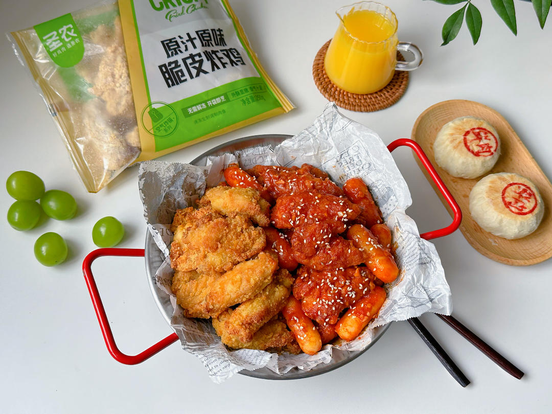 Double-flavor fried chicken with rice cakes, half in a red spicy glaze