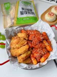 Plate the glazed chicken with sesame seeds and the plain crispy half