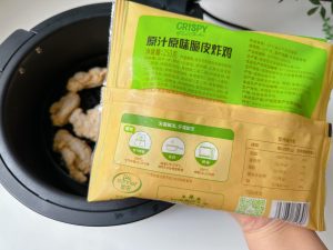 Load the frozen chicken into the air fryer without thawing